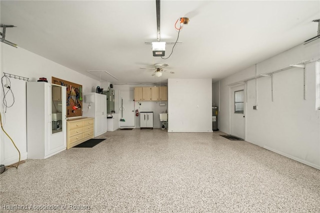 1904 Mulligan Rd, Sebring, FL 33872 - garage featuring ceiling fan, a garage door opener, baseboards, and water heater