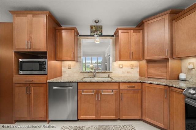 1904 Mulligan Rd, Sebring, FL 33872 - kitchen featuring appliances with stainless steel finishes, a sink, light stone counters, decorative backsplash, and brown cabinetry