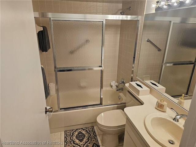 bathroom with vanity, toilet, tile patterned flooring, and shower / bath combination with glass door