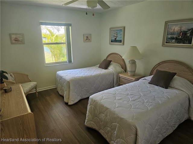 bedroom with a ceiling fan, wood finished floors, and baseboards