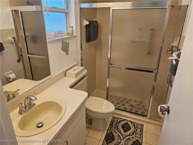 full bath with tile patterned floors, a shower stall, toilet, and vanity