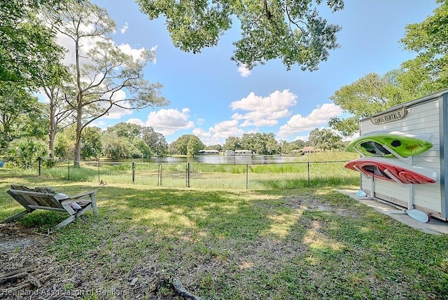 view of yard with fence and a water view