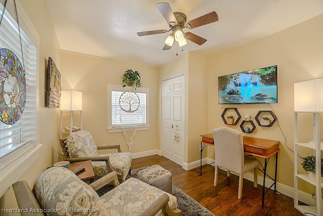 office featuring ceiling fan, baseboards, and dark wood finished floors