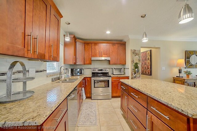 kitchen featuring under cabinet range hood, light stone countertops, stainless steel appliances, and a sink