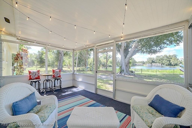 sunroom / solarium featuring a water view and an outdoor hangout area