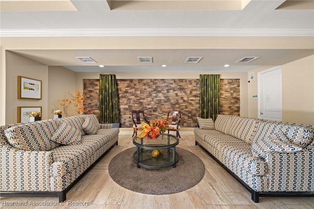 living room featuring wood-type flooring and ornamental molding