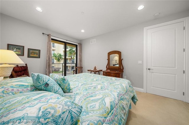 bedroom with light carpet and access to exterior