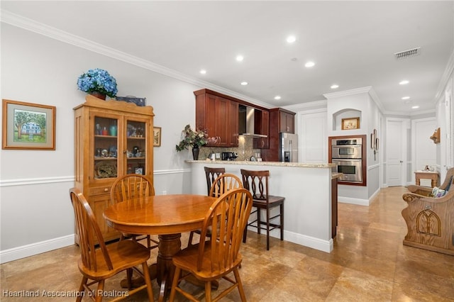 dining space featuring ornamental molding