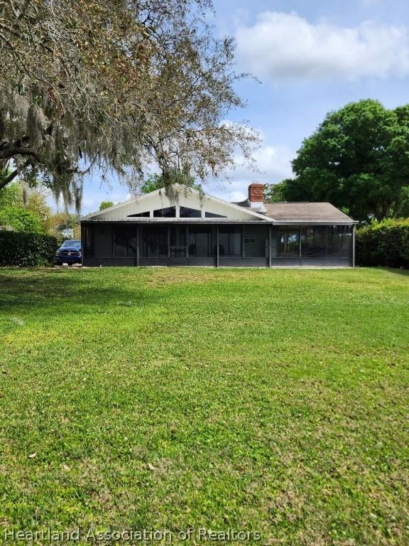 view of yard featuring a sunroom