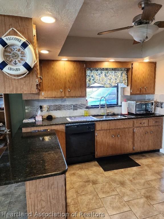 kitchen with dishwasher, sink, ceiling fan, a textured ceiling, and tasteful backsplash