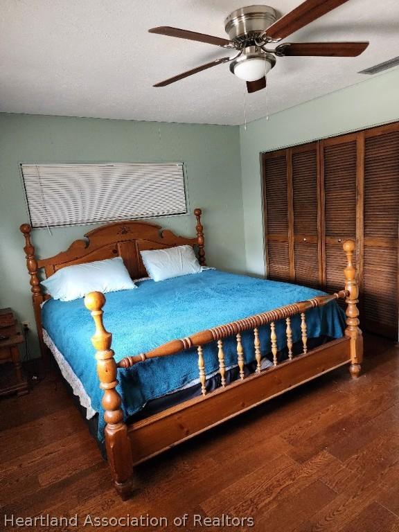 bedroom featuring dark hardwood / wood-style flooring and ceiling fan