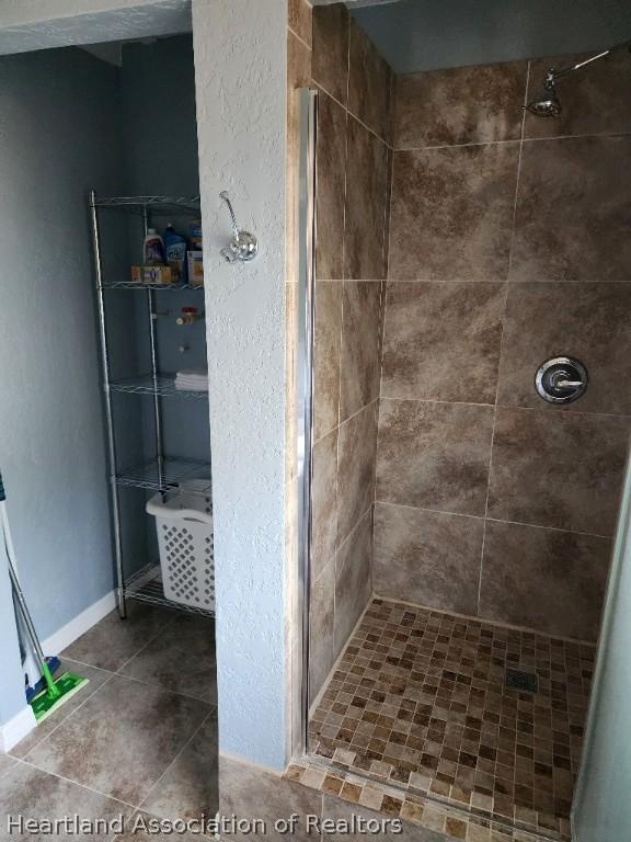 bathroom with tiled shower