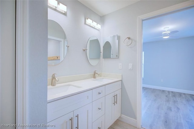 bathroom featuring hardwood / wood-style flooring, ceiling fan, and vanity