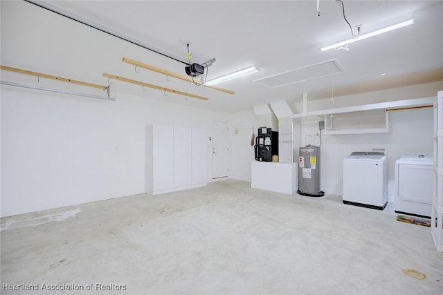 garage featuring independent washer and dryer, a garage door opener, and water heater