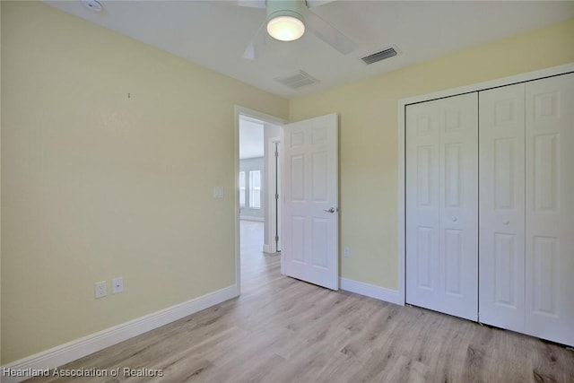 unfurnished bedroom featuring light hardwood / wood-style flooring, a closet, and ceiling fan