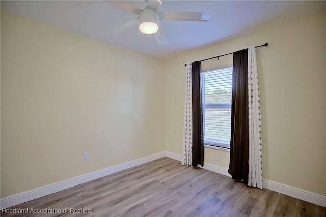 empty room with ceiling fan and light wood-type flooring