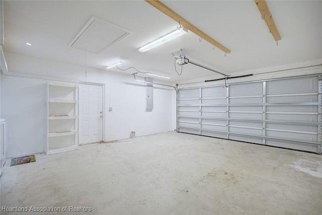 garage with a garage door opener and electric panel