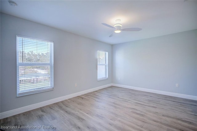 unfurnished room featuring ceiling fan and light hardwood / wood-style flooring