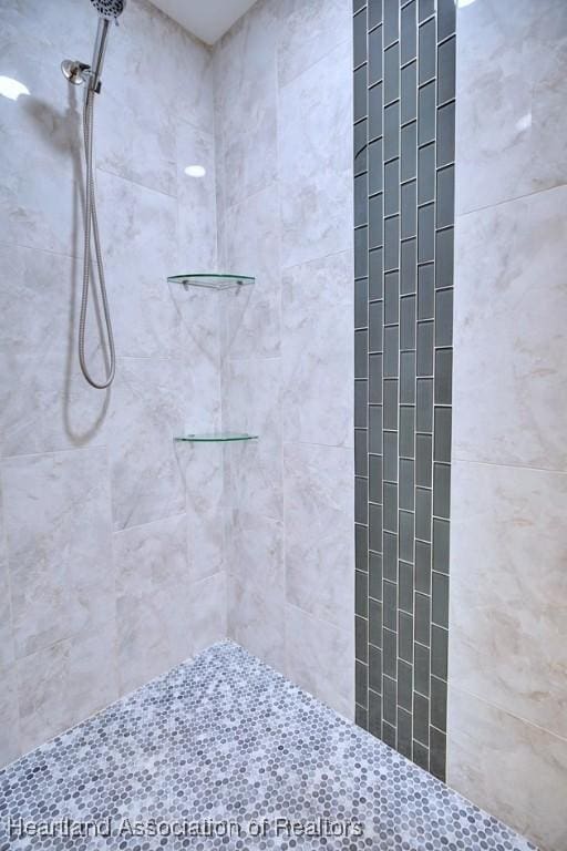 bathroom with a tile shower