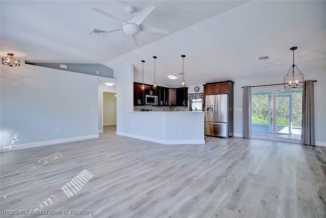 unfurnished living room with lofted ceiling, ceiling fan with notable chandelier, and light hardwood / wood-style floors