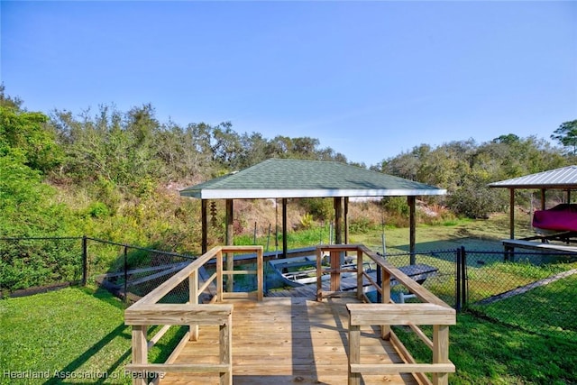 exterior space with a wooden deck, a gazebo, and a lawn