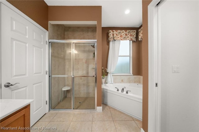3038 Cedora Ter, Sebring, FL 33870 - full bathroom with a shower stall, vanity, a garden tub, and tile patterned floors