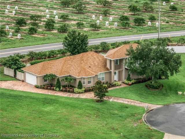 3038 Cedora Ter, Sebring, FL 33870 - view of front of property with an attached garage, stucco siding, a front yard, and driveway