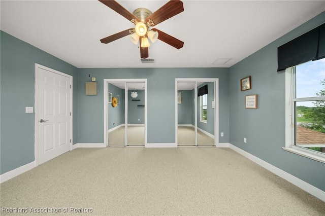3038 Cedora Ter, Sebring, FL 33870 - unfurnished bedroom featuring multiple closets, carpet flooring, and a ceiling fan