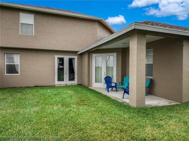 3038 Cedora Ter, Sebring, FL 33870 - back of house with french doors, stucco siding, a lawn, and a patio