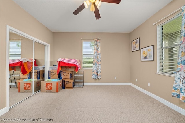 3038 Cedora Ter, Sebring, FL 33870 - playroom featuring a ceiling fan, carpet floors, and plenty of natural light