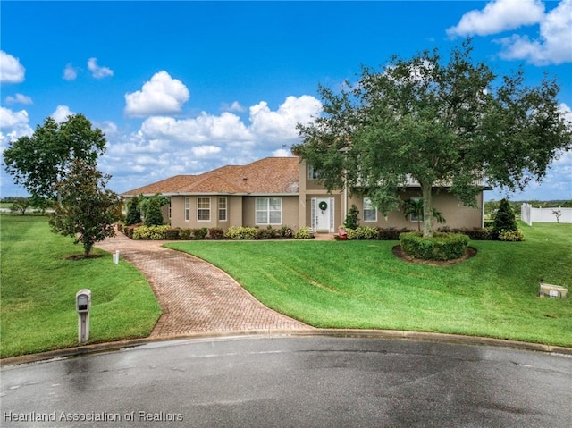 3038 Cedora Ter, Sebring, FL 33870 - ranch-style home featuring decorative driveway, a front yard, and stucco siding