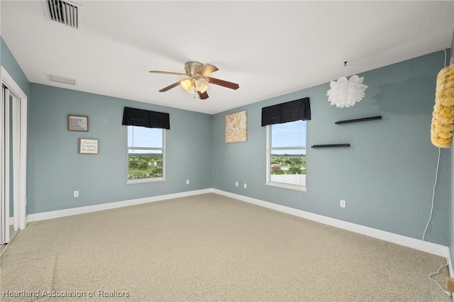 3038 Cedora Ter, Sebring, FL 33870 - unfurnished bedroom with multiple windows, carpet flooring, and ceiling fan