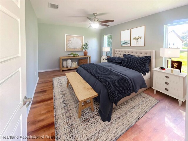 empty room with ceiling fan and dark hardwood / wood-style flooring