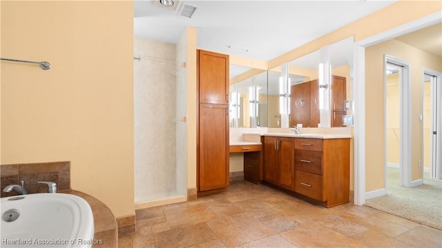 full bathroom with a shower, a garden tub, visible vents, vanity, and baseboards