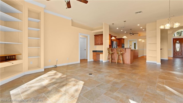 unfurnished living room featuring baseboards, visible vents, ceiling fan with notable chandelier, built in shelves, and recessed lighting