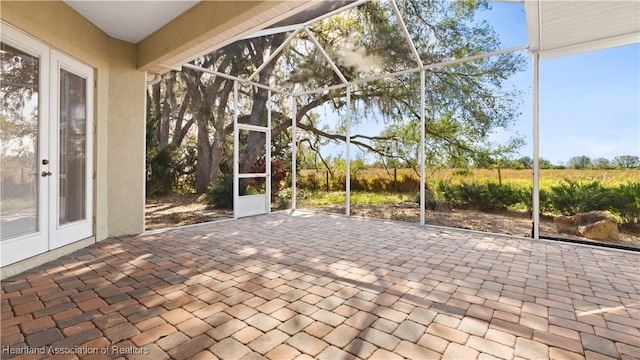 unfurnished sunroom featuring french doors