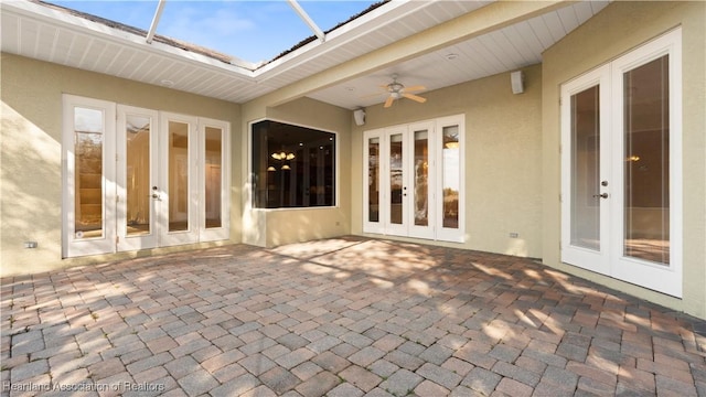 view of patio / terrace with french doors, ceiling fan, and a lanai