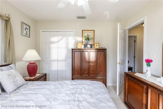 bedroom with light carpet, a closet, and ceiling fan