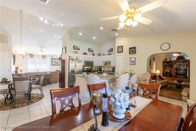 dining area featuring light tile patterned flooring, high vaulted ceiling, and ceiling fan