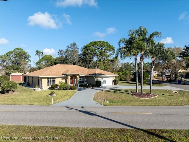 ranch-style home with a garage and a front yard