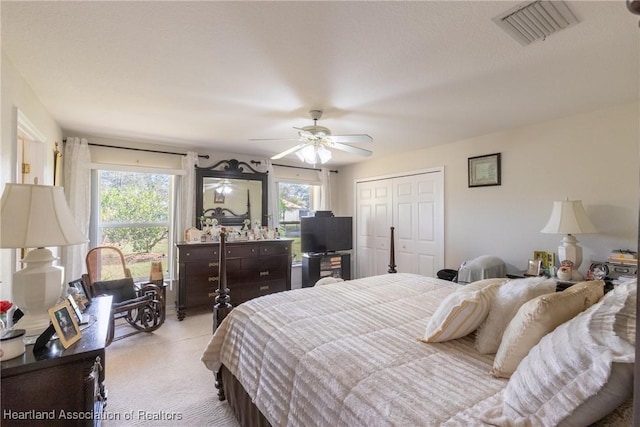 carpeted bedroom with a closet and ceiling fan