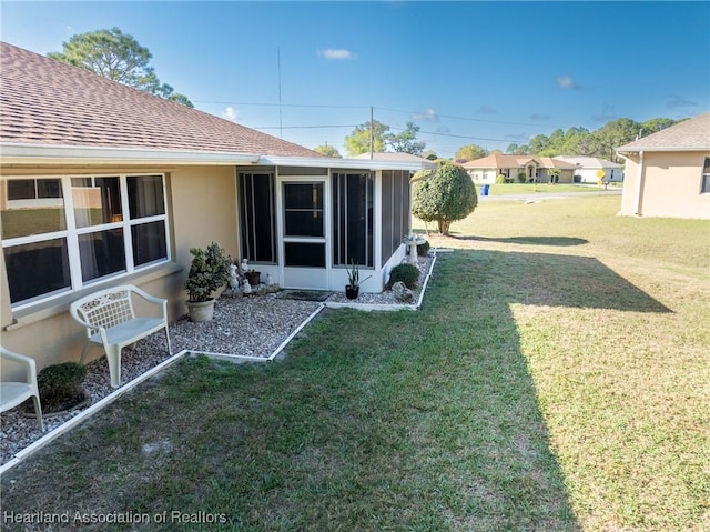 view of yard with a sunroom