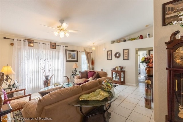 living room with light tile patterned flooring, ceiling fan, and lofted ceiling