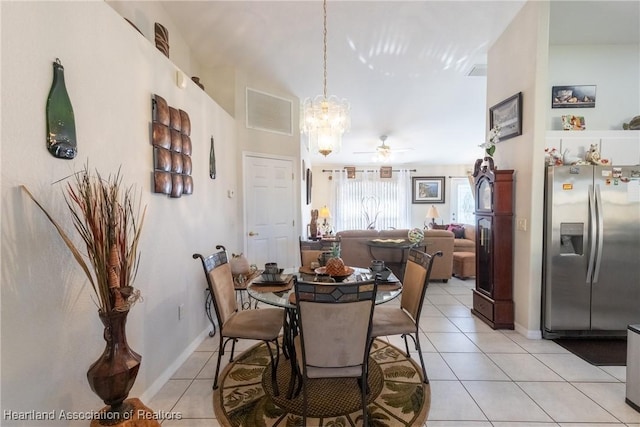 dining area featuring ceiling fan with notable chandelier and light tile patterned floors