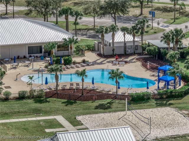 view of pool with a lawn and a playground