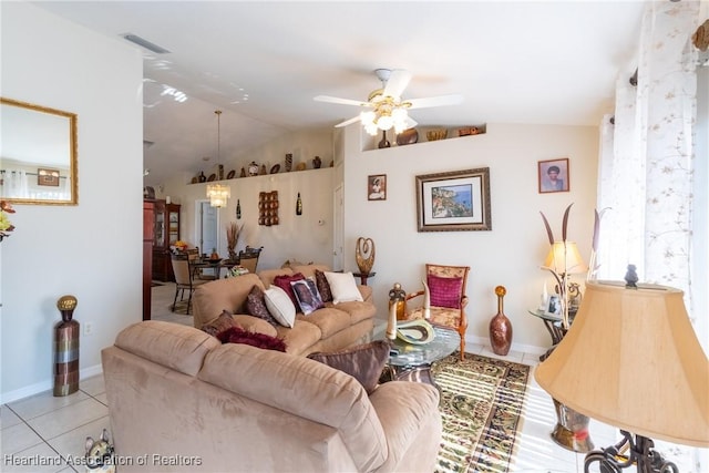 living room featuring light tile patterned flooring, ceiling fan, and vaulted ceiling