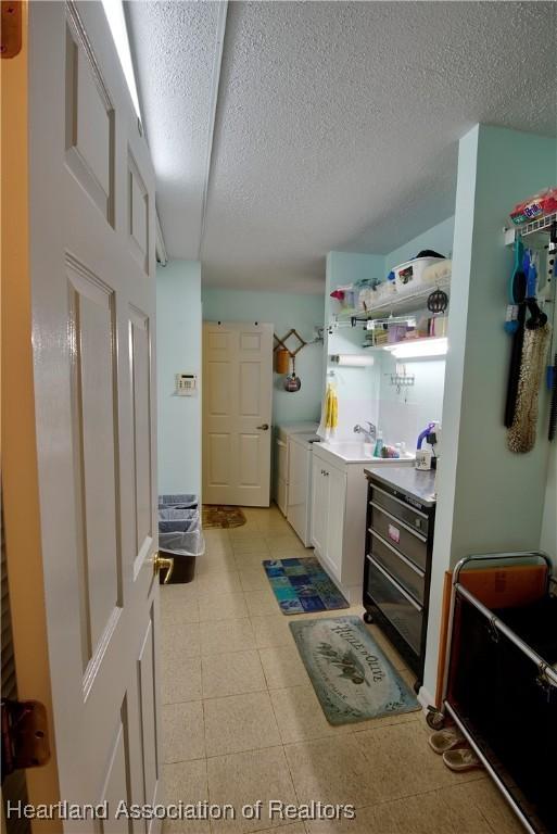 interior space featuring a textured ceiling, independent washer and dryer, and laundry area