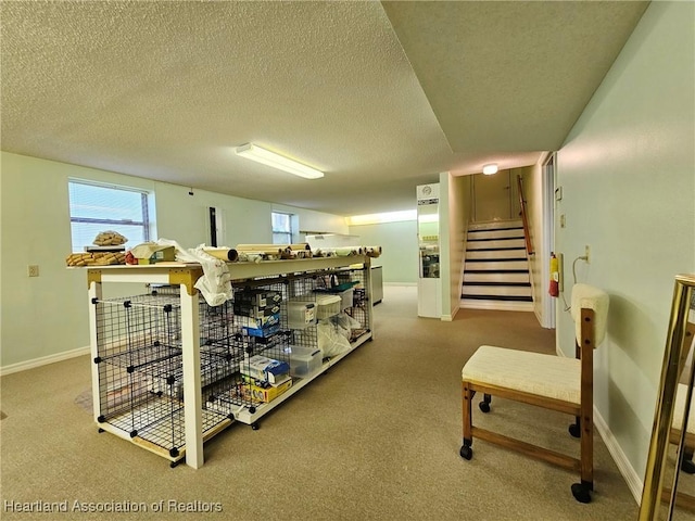 interior space with carpet, stairway, and a textured ceiling