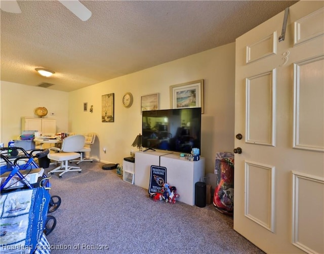 carpeted living room featuring a textured ceiling