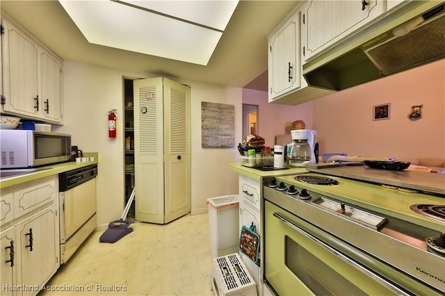 kitchen with white cabinets, dishwasher, and electric range